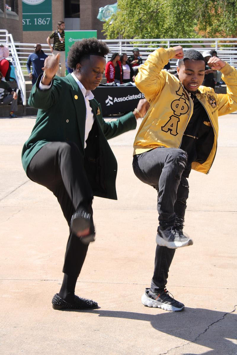 Two students in Alpha Phi Alpha Fraternity, Inc. perform a step routine at a CSU campus event.