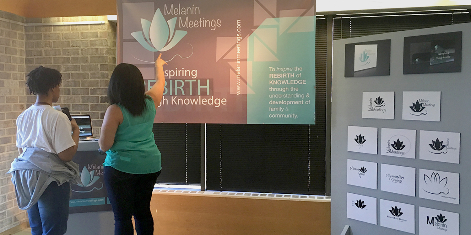 Student Exhibition Two students looking at design work in senior exhibition