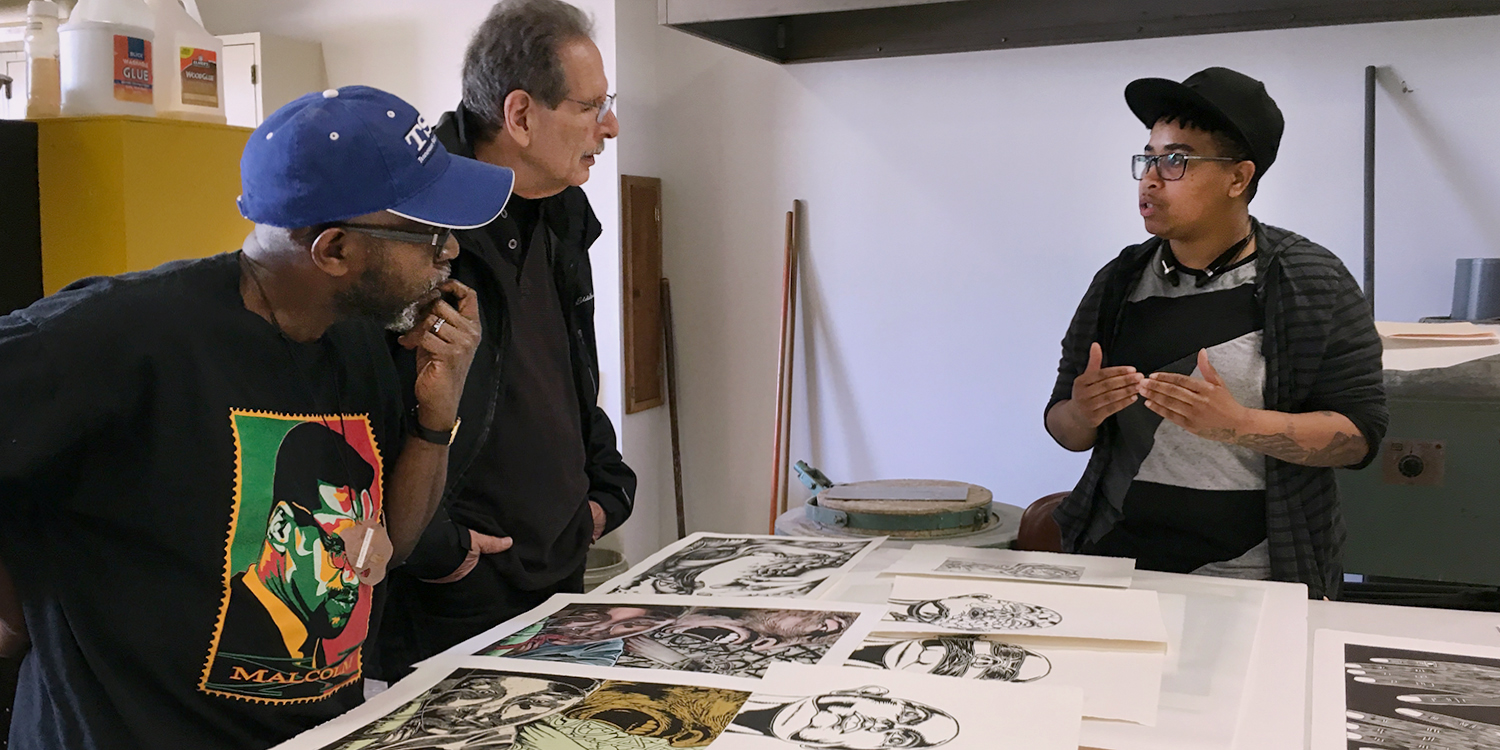 Diaspora Rhythms Student discussing prints and drawings with artists
