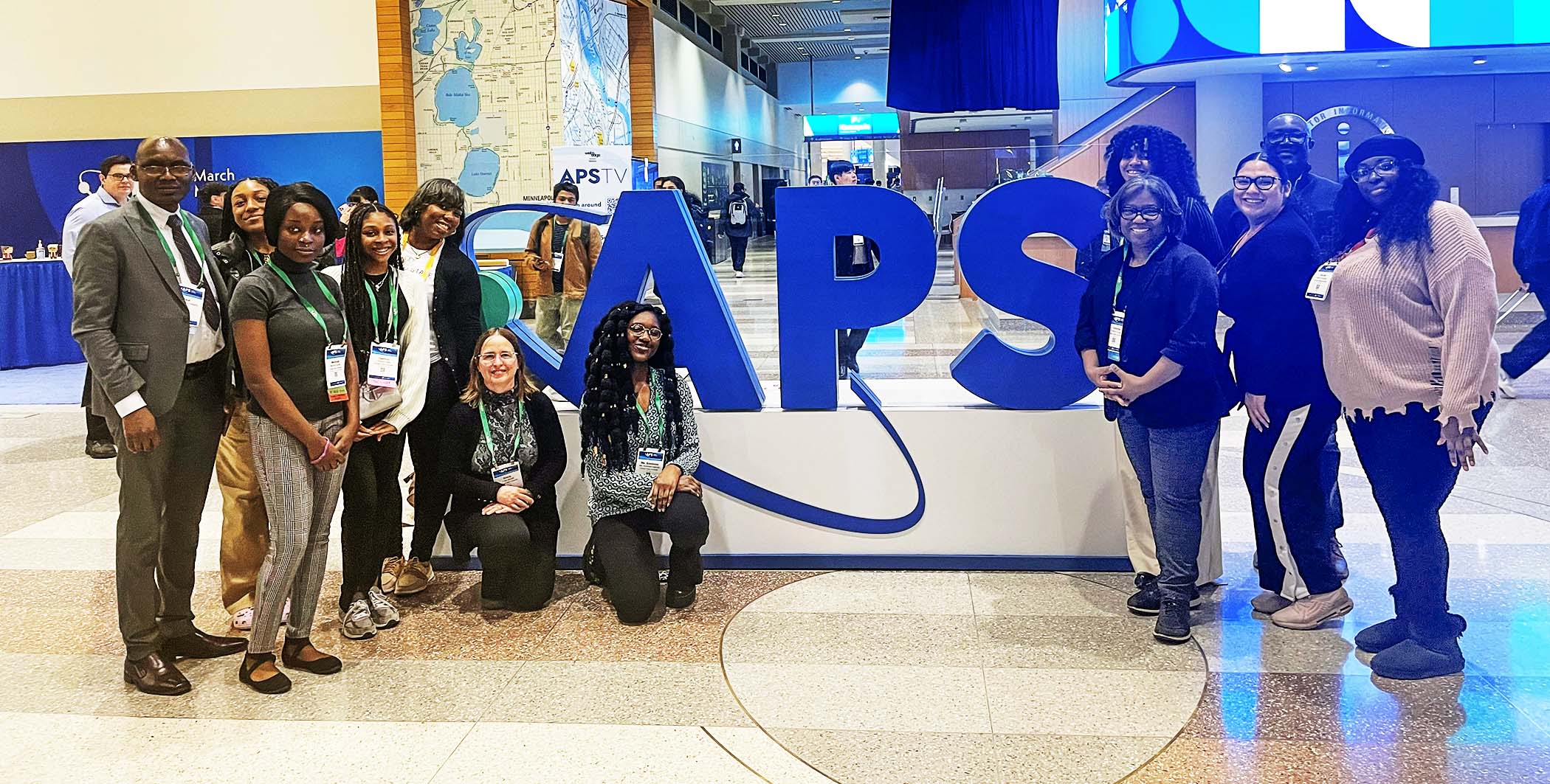 CSU Students and Faculty with the large APS sign in the background.