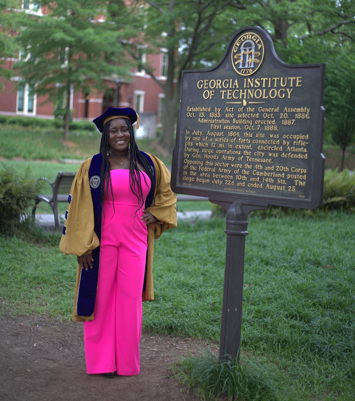 PhD graduate in cap and gown.