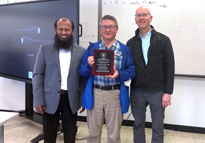 Dr. Chern smiles while holding a plaque while CIMST chair Dr. Salam and Dean Mark Smith (College of Arts and Science) smile and stand alongside him.