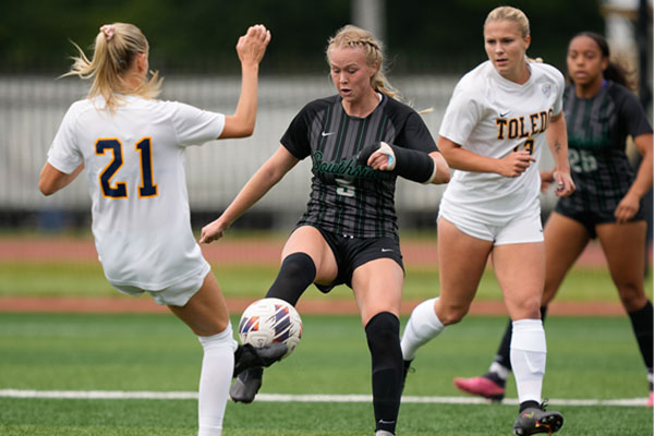 CSU Female Soccer Player Kicking Soccer Ball