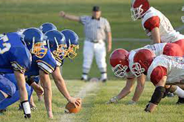 Footbal team about to hike tha ball