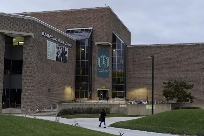 Chicago State University's Business and Health Sciences building with a person walking towards the entrance.